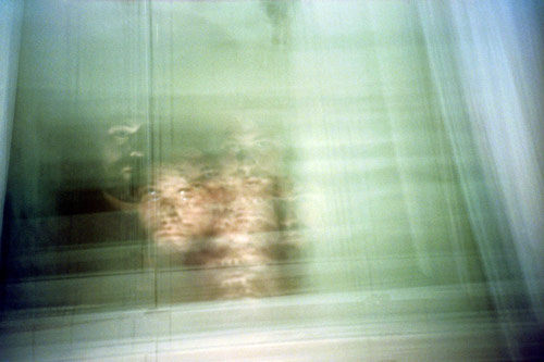 [A multiply-exposed photograph of my face in a mirror.]