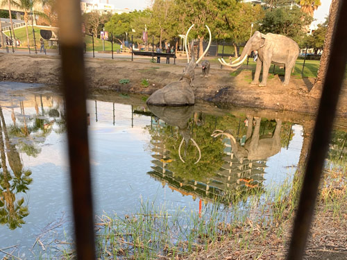 ["Around LA" page header
photograph. New luxury residential construction seen reflected in a tar pit.]
